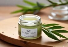 Tea Tree Gel: Benefits, Uses, Alternatives & Buying Guide Tea tree gel in a clear jar with fresh tea tree leaves on wooden surface, representing natural skincare and healing benefits.
