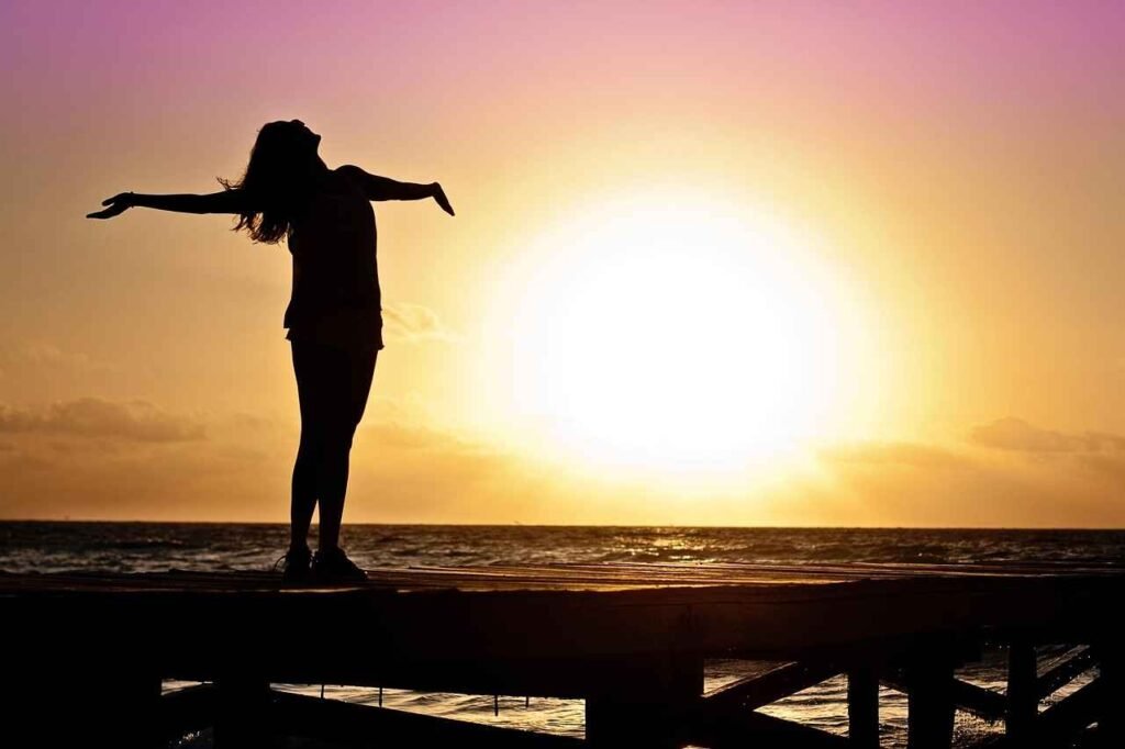 a girl on beach at time of sunset at background